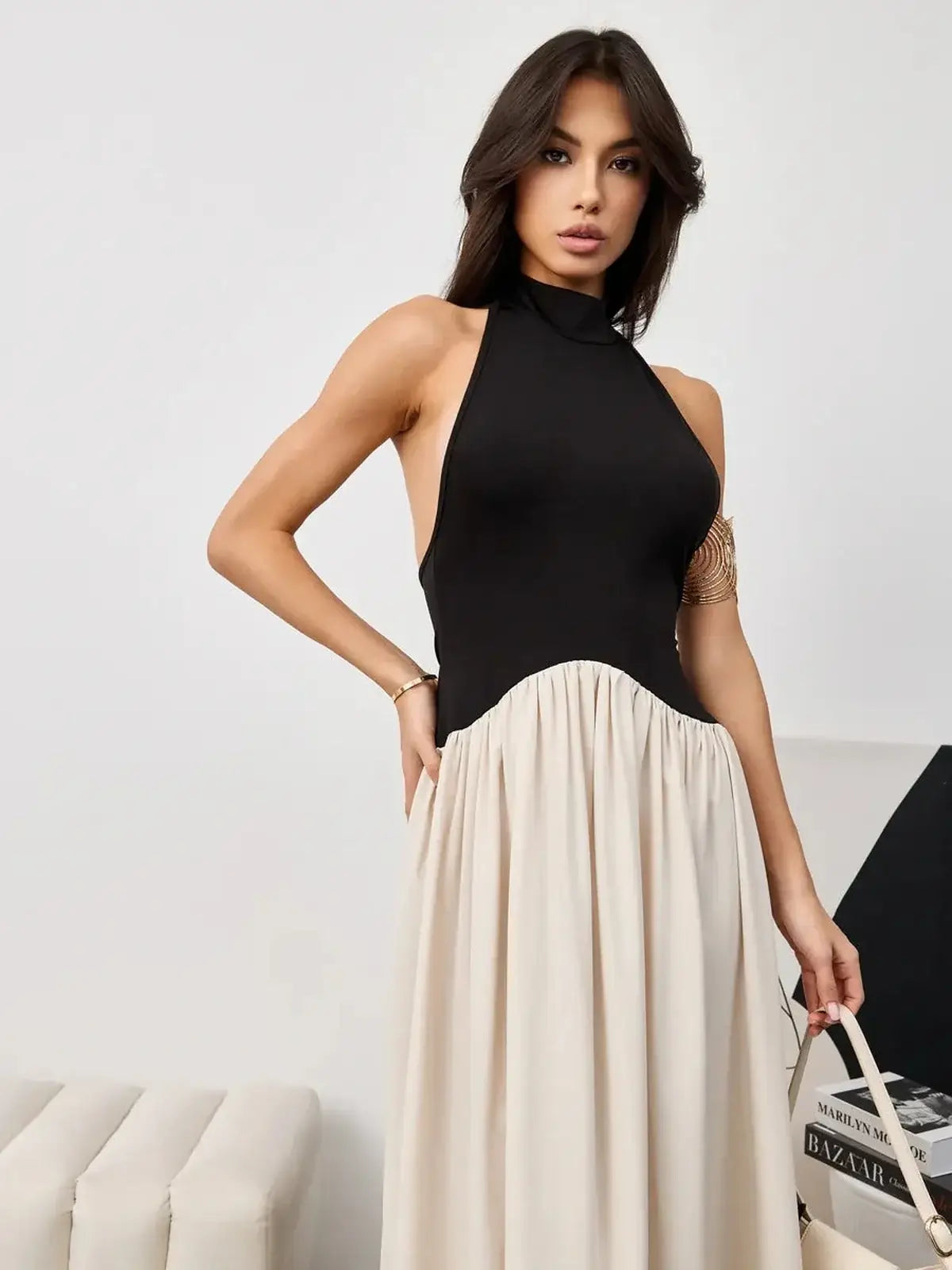 Muse Hourglass evening dress featuring a black halter bodice and beige voluminous skirt, perfect for formal occasions.