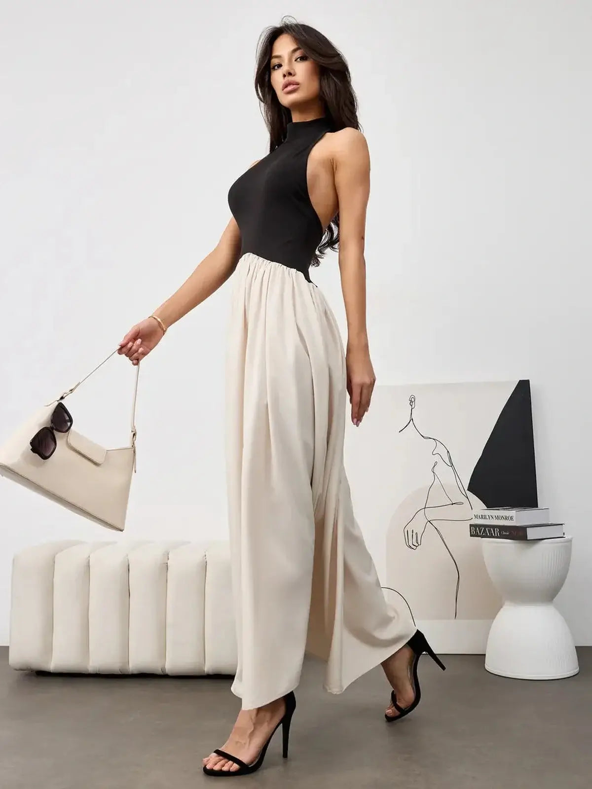 Muse Hourglass midi dress featuring a sleek black halter bodice and a flowing beige skirt for elegant evening style.