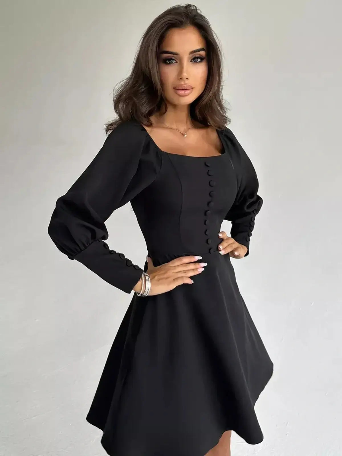 Model showcasing the Noir Aura Mini Dress with puffed sleeves and button-down detail, perfect for formal occasions.