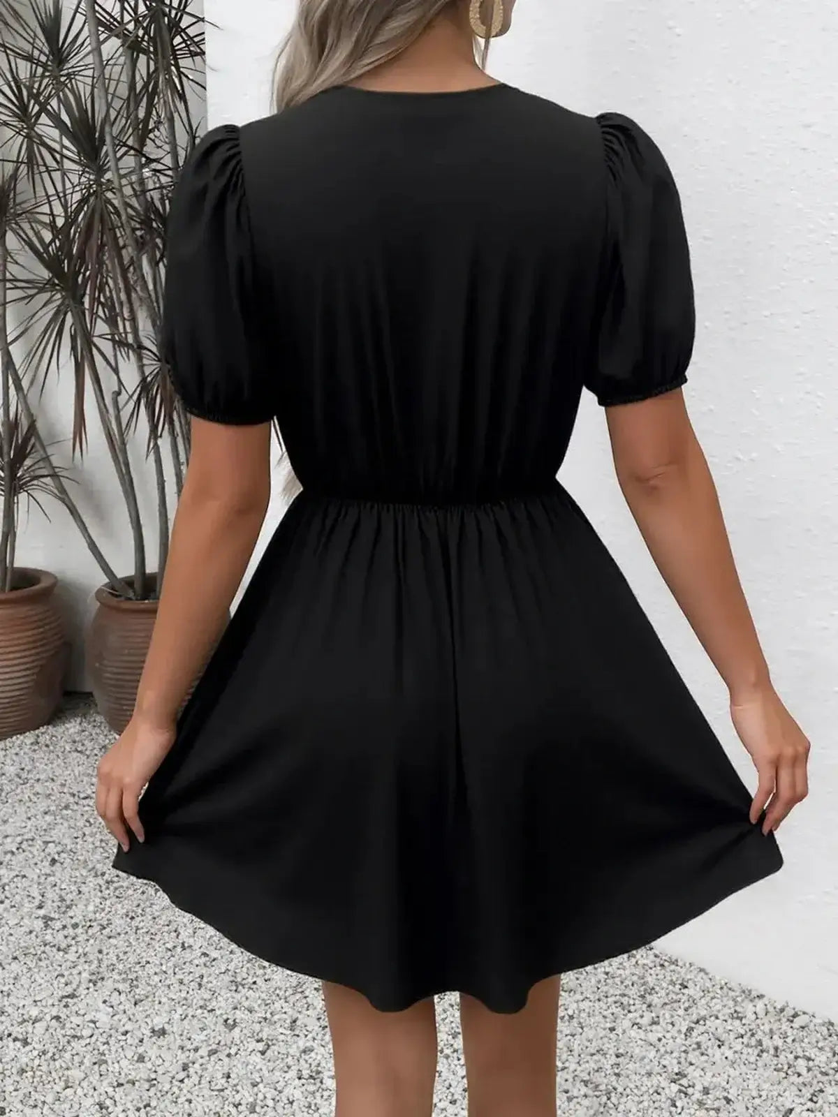 Black mini dress with puff sleeves, perfect for summer parties, weddings, and casual gatherings.