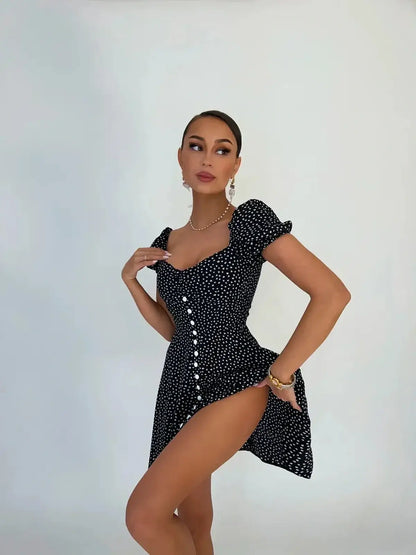 Model wearing a black polka dot mini dress with puff sleeves, showcasing a chic summer style and flattering silhouette.