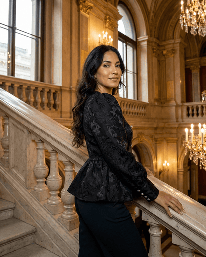 Woman in a Noir Corset Top by Slimona, showcasing a refined design with puff sleeves and tailored structure.