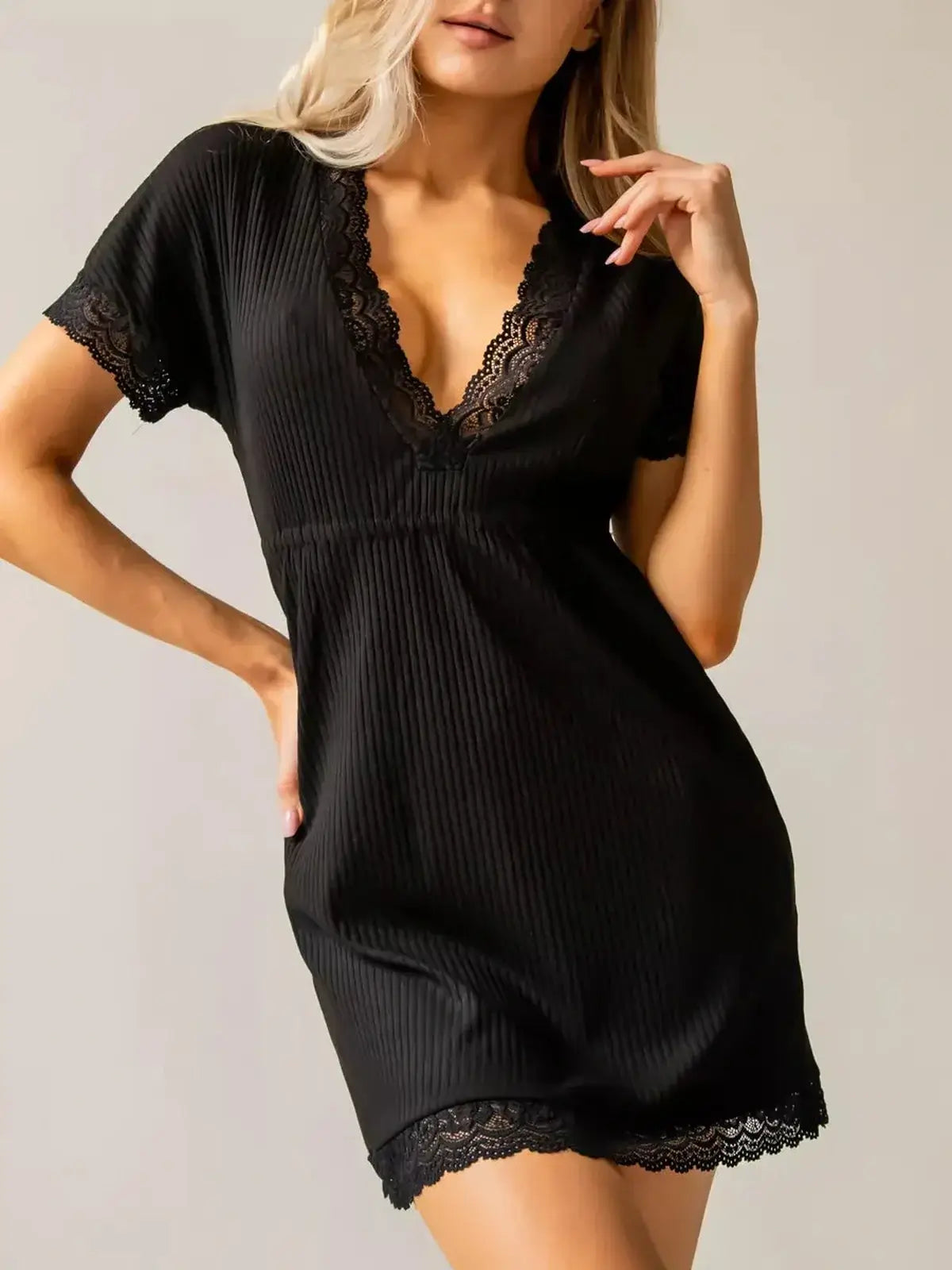 Stylish black mini dress with lace trim and plunging V-neck, perfect for summer parties and elegant occasions.