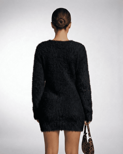 Back view of a model wearing the Slimona Noir Sweater, showcasing its plush texture and loose fit.