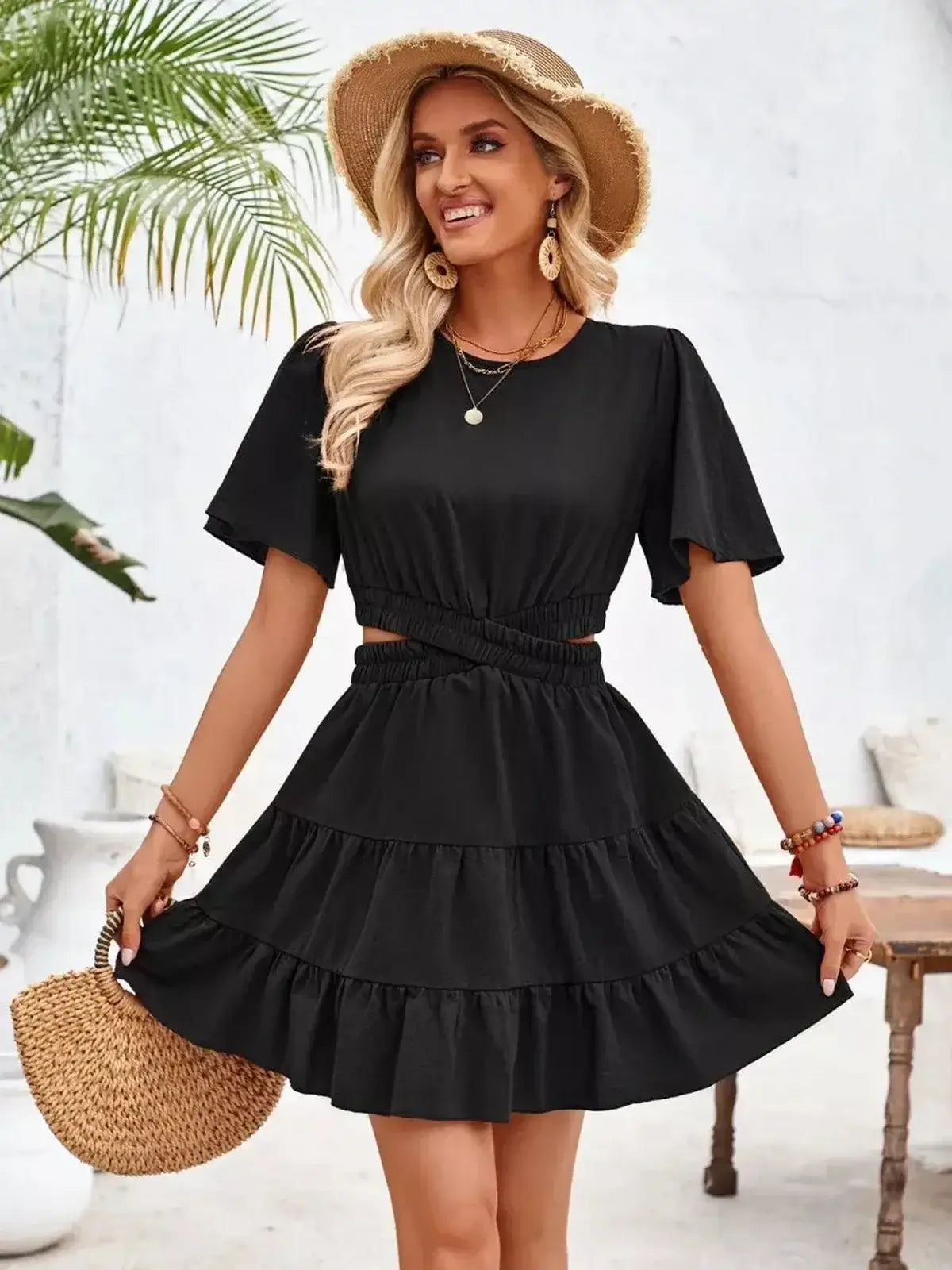 Black mini dress with tiered skirt and short sleeves, perfect for summer and cocktail events.