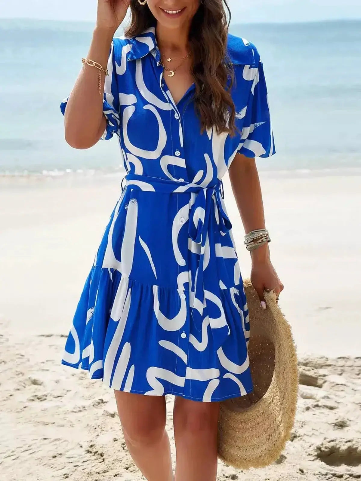 Ocean Script Mini Dress in bold blue and white abstract pattern, perfect for summer outings and wedding guest outfits.