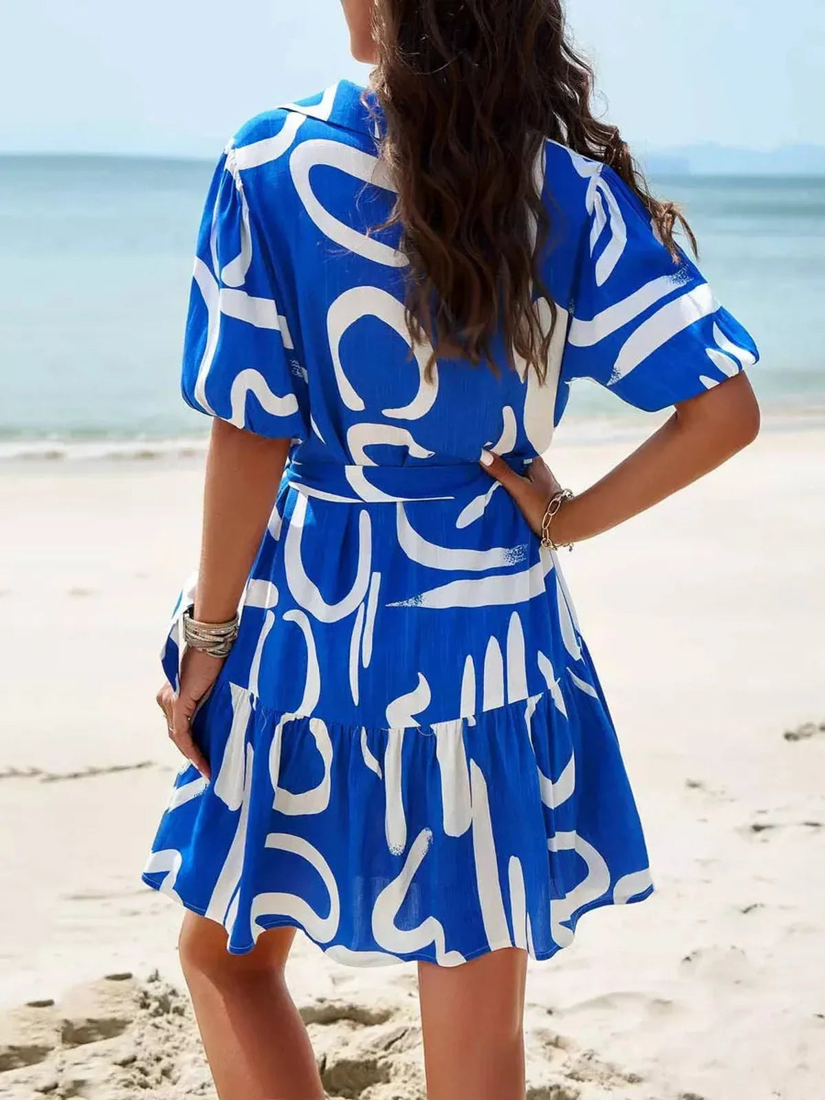 Back view of Ocean Script Mini Dress featuring blue-and-white abstract pattern, perfect for summer dresses and beach outings.