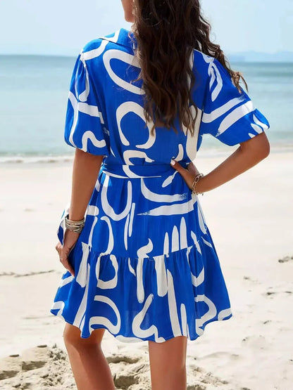 Back view of Ocean Script Mini Dress featuring blue-and-white abstract pattern, perfect for summer dresses and beach outings.