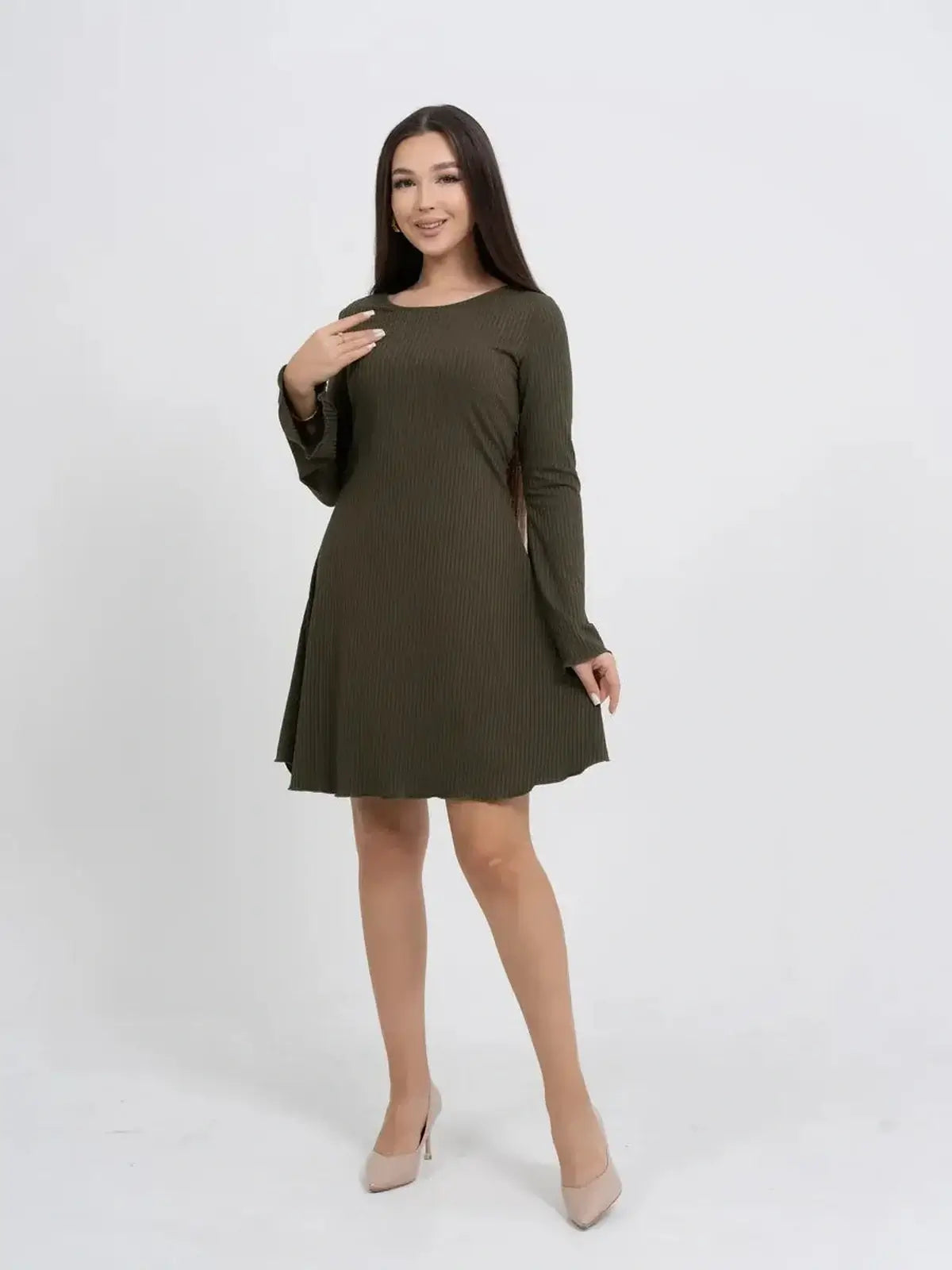 Model wearing a long sleeve olive green mini dress with a flowy silhouette and bell sleeves.