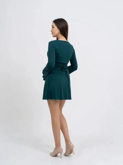 Model showcasing the Olive Muse long sleeve mini dress in green, perfect for casual or formal occasions.