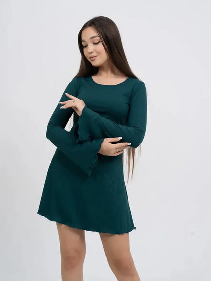 Model wearing a Ripple Flare long sleeve mini dress in teal, showcasing bell sleeves and a flattering silhouette.