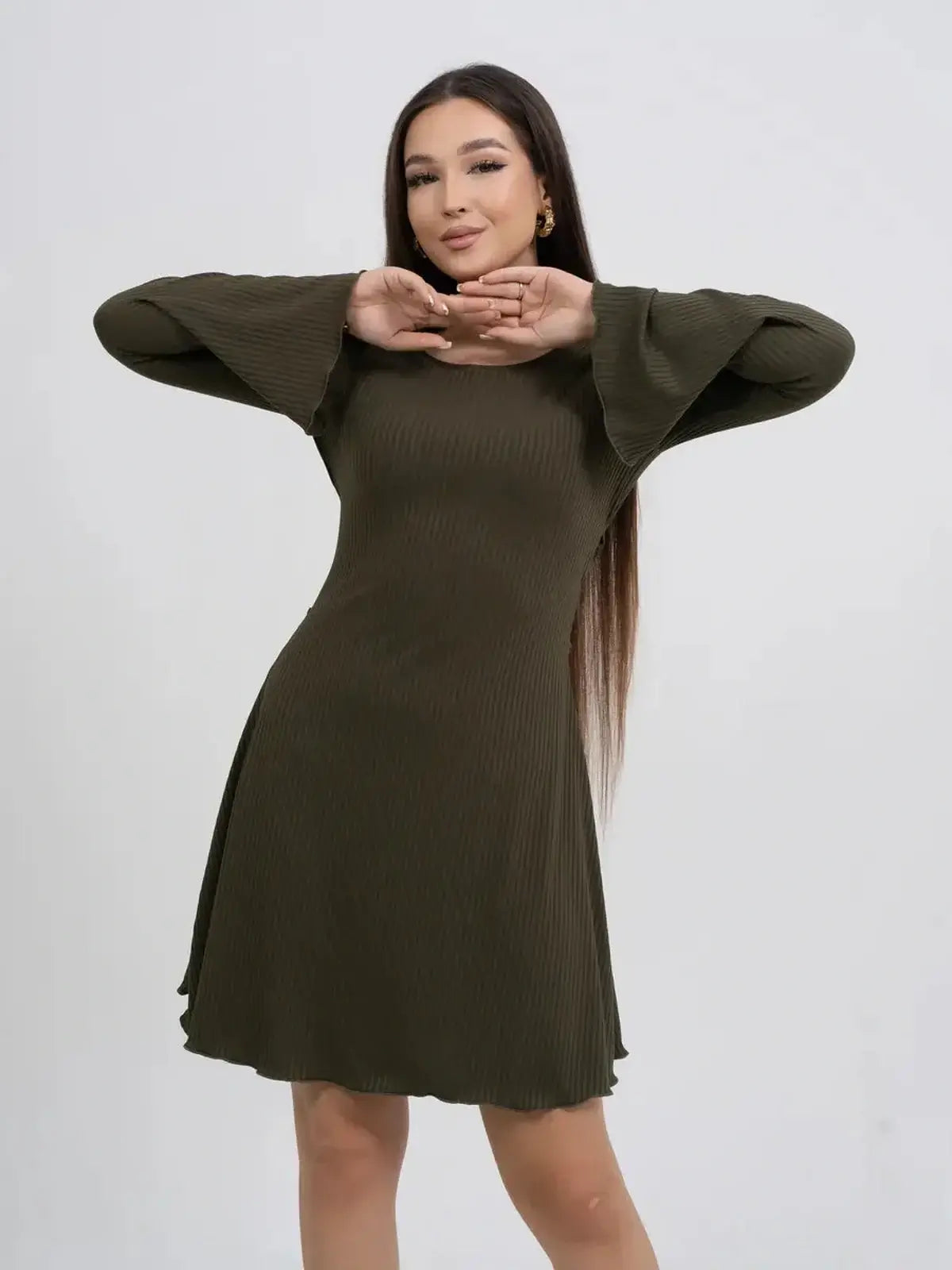 Olive Muse long sleeve mini dress in ribbed stretch-knit fabric with bell sleeves and flattering silhouette.