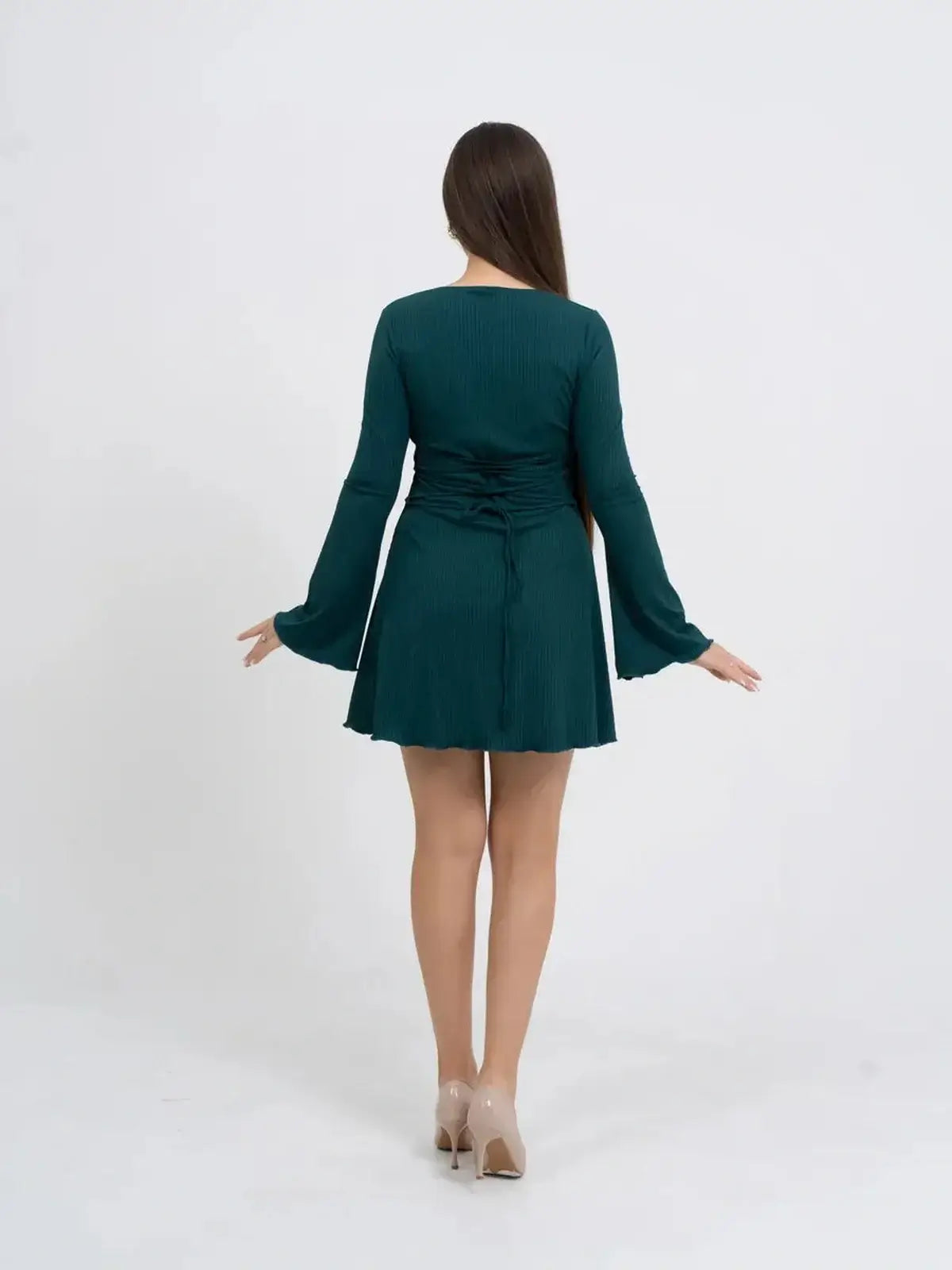 Long sleeve mini dress in emerald green with ruched details and flowy bell sleeves, perfect for formal or casual occasions.
