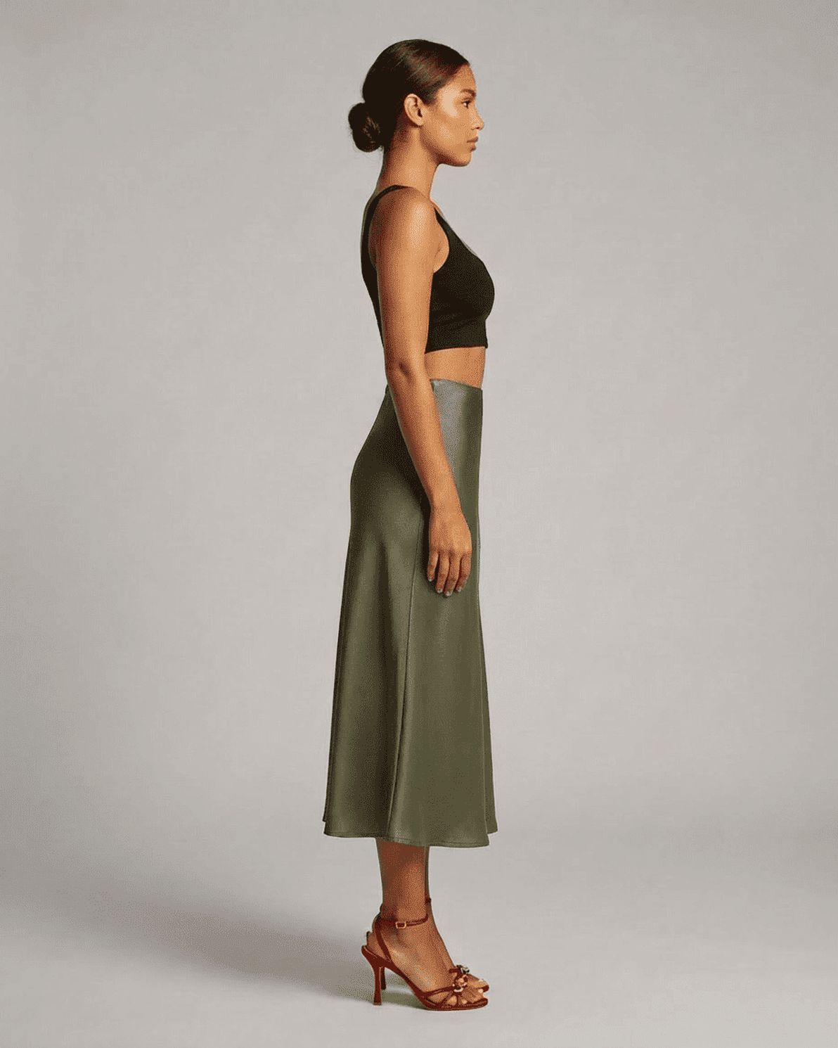 Olivia Midi Skirt by Slimona in olive green, showcasing elegant satin mermaid silhouette from the side.
