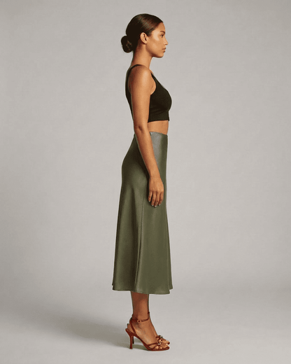 Olivia Midi Skirt by Slimona in olive green, showcasing elegant satin mermaid silhouette from the side.