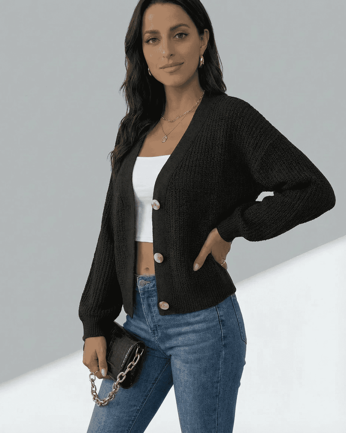 Orion Cardigan by Slimona, stylish black long sleeve v-neck knitwear worn over a white tank.