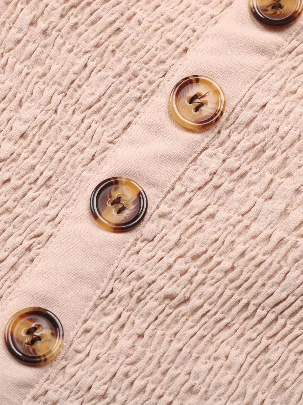 Close-up of buttons on the Palm Bay Mini Dress, featuring textured fabric and a stylish button-down front.