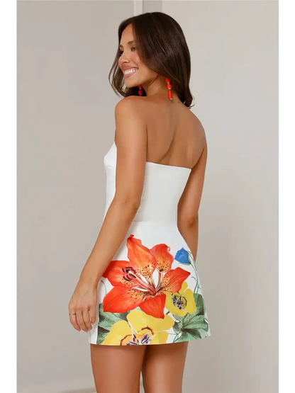 Model wearing the Petal Muse white midi dress with vibrant floral print, perfect for summer weddings and casual events.