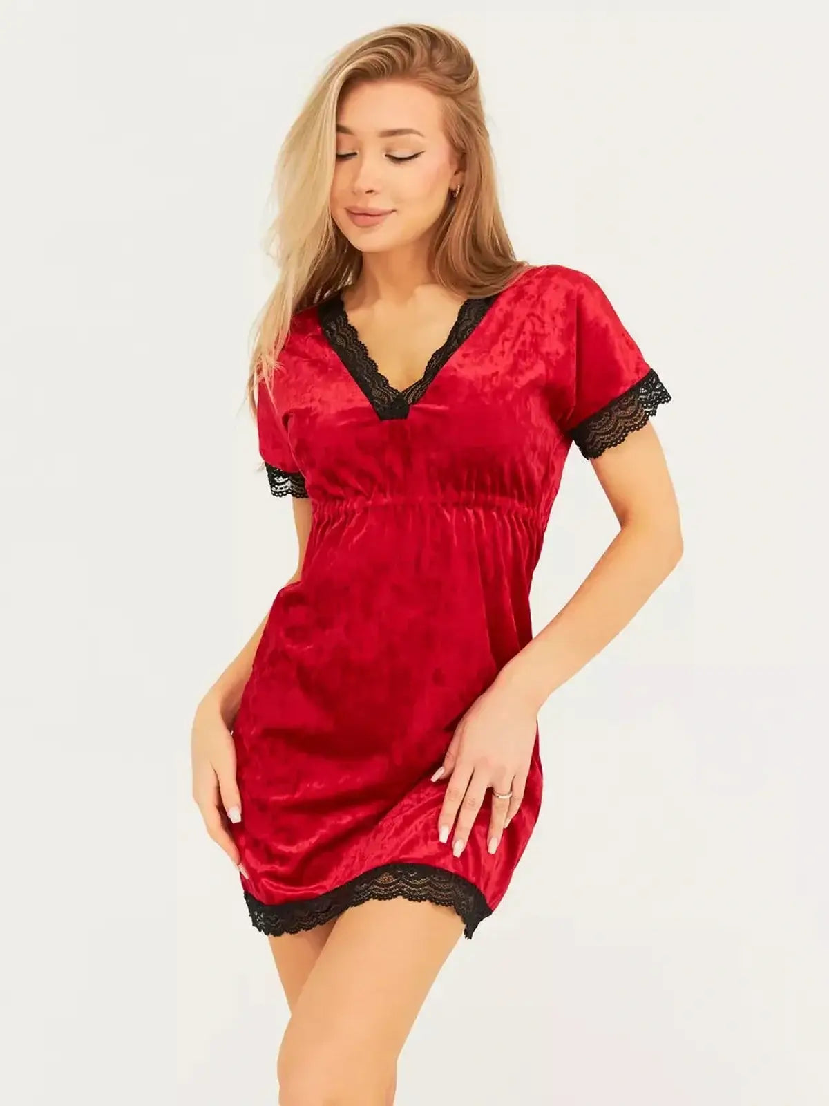 Model wearing a red velvet mini dress with black lace trim, perfect for parties and special occasions.