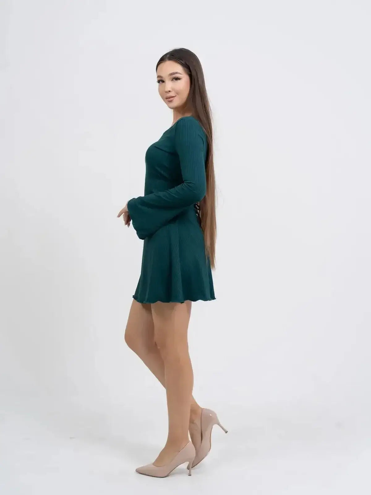 Model wearing a teal long sleeve mini dress with flared sleeves, perfect for summer parties and casual outings.