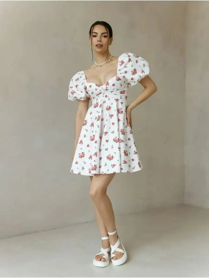 White floral mini dress with puff sleeves, perfect for summer, weddings, and special occasions.