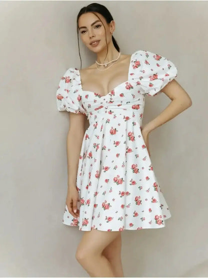 Rosabelle Mini Dress featuring a floral design with puff sleeves, perfect for summer and wedding guest outfits.