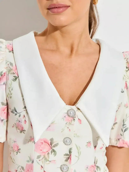 Close-up of Rose Charm floral mini dress featuring a white collar and pink floral patterns, perfect for summer occasions.