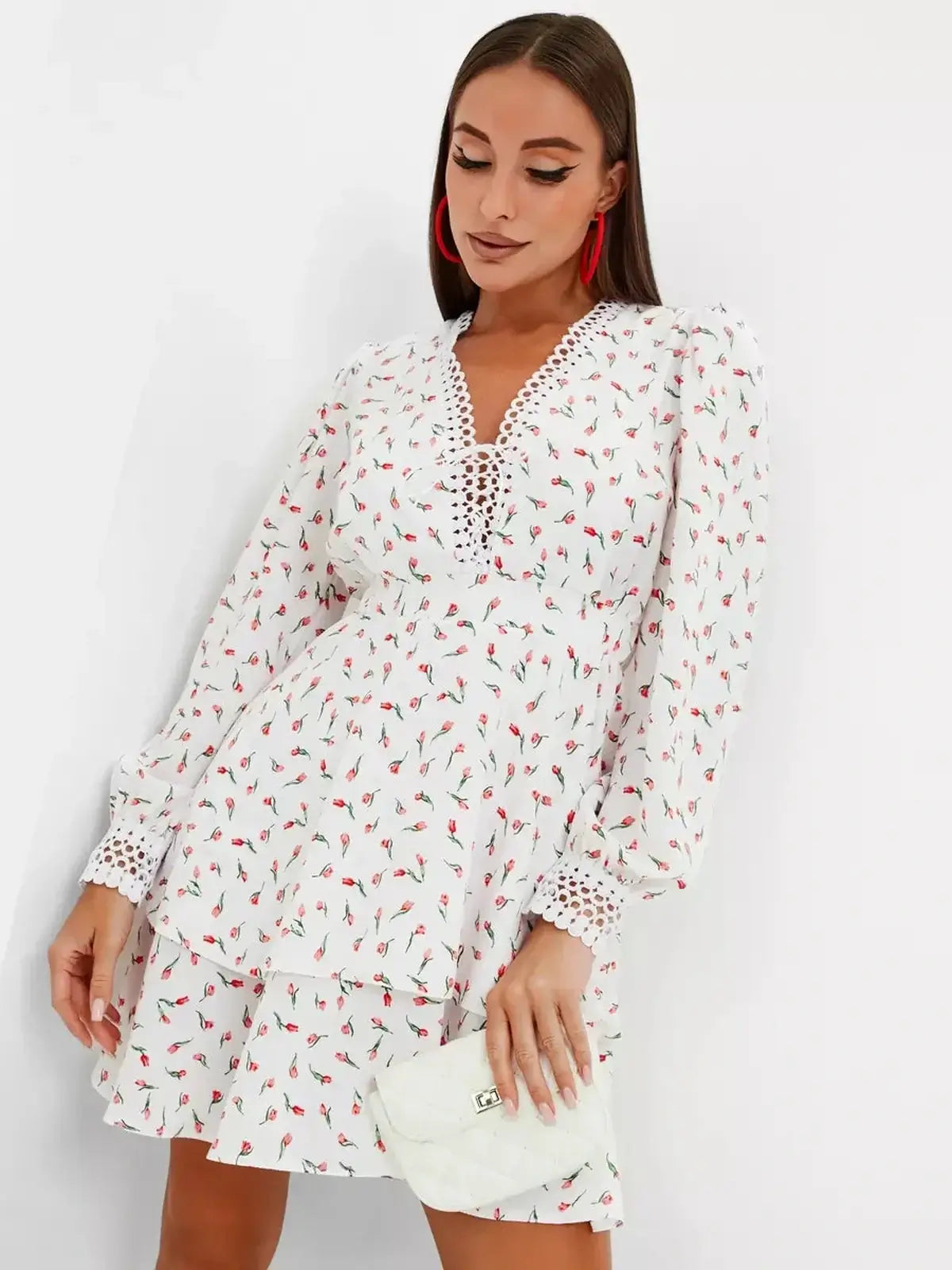 Elegant white mini dress with rosebud print and long sleeves, perfect for summer parties or wedding guest attire.