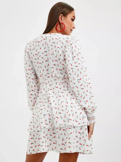 Back view of a white floral midi dress with long sleeves and a ruffled hem, perfect for summer celebrations.