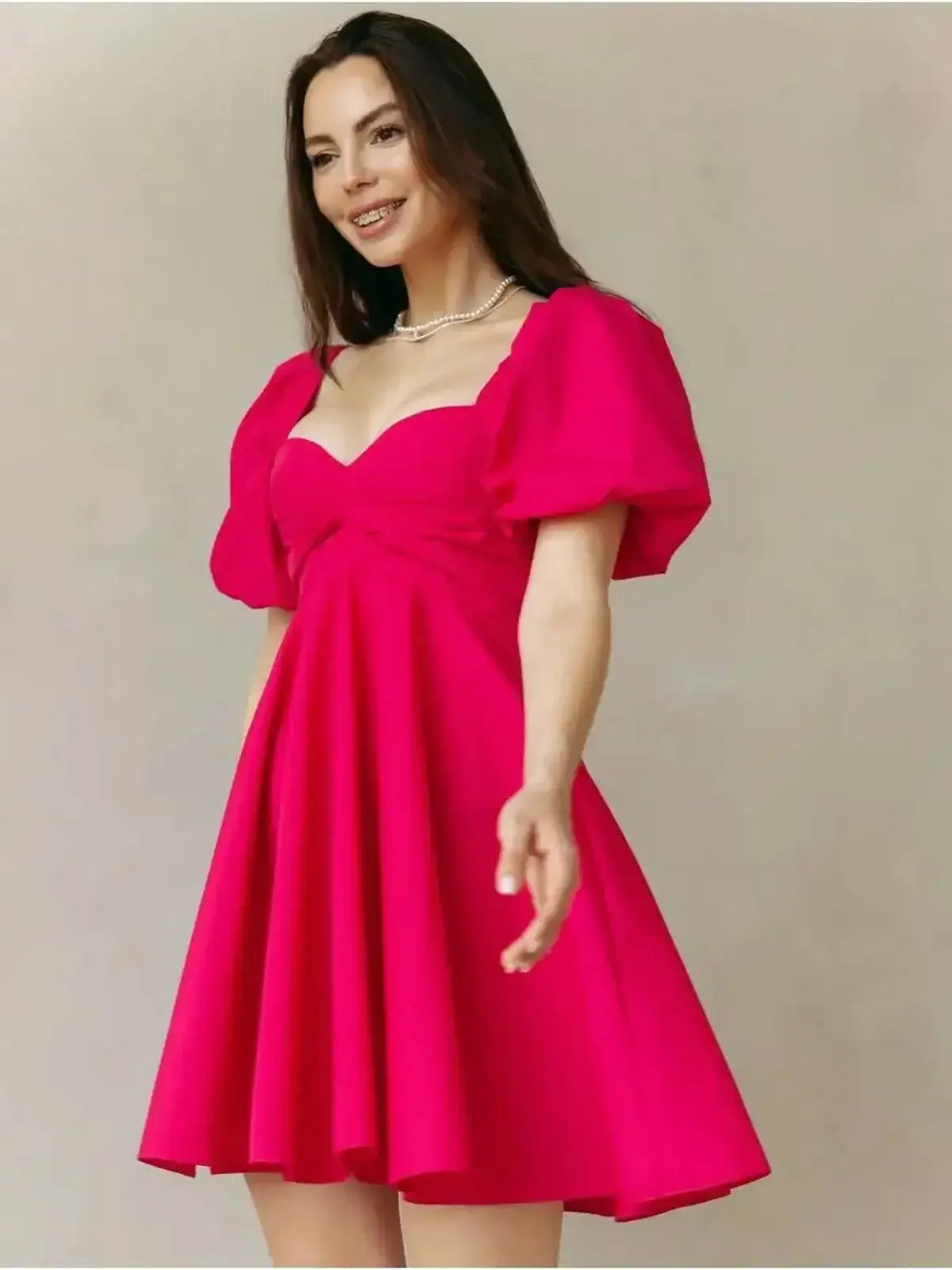 Bright pink Rose Fizz Mini Dress with puff sleeves and gathered bust, perfect for summer parties or weddings.