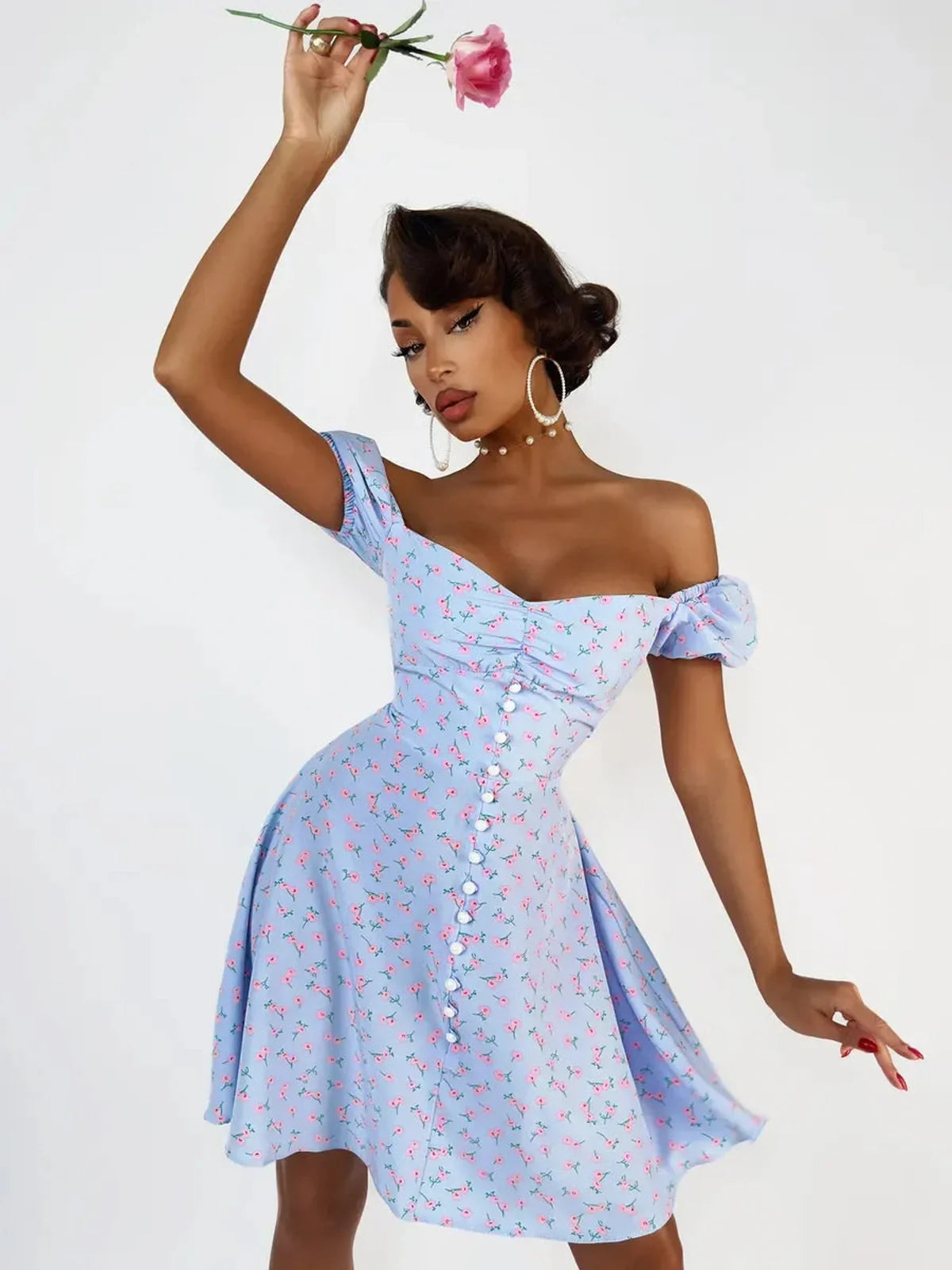 Model showcasing a baby blue Rose Petal Mini Dress with pink floral print, perfect for summer parties and weddings.