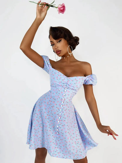 Model showcasing a baby blue Rose Petal Mini Dress with pink floral print, perfect for summer parties and weddings.