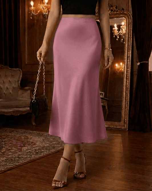 Roselle Midi Skirt by Slimona – Elegant satin mermaid midi skirt in delicate pink, enhancing the waist and flowing gracefully.
