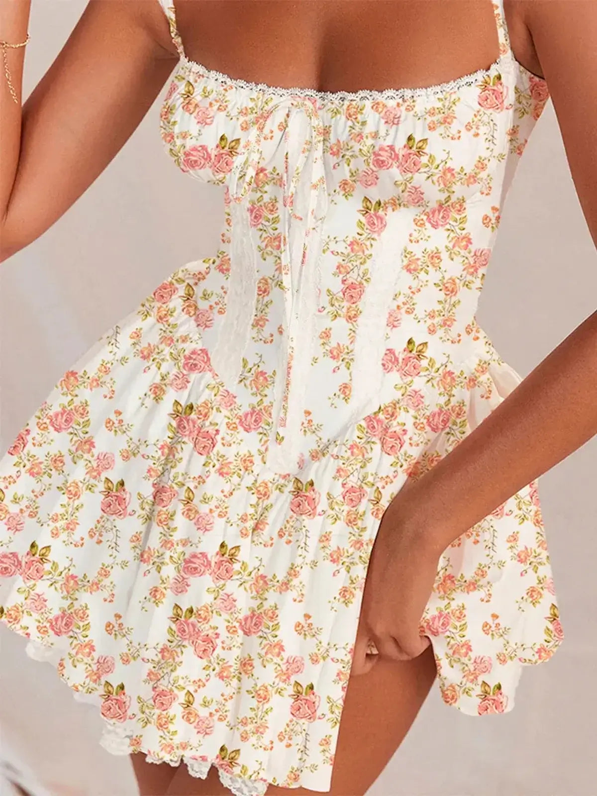 Floral mini dress with lace-up bodice and rose print, perfect for summer weddings and parties.