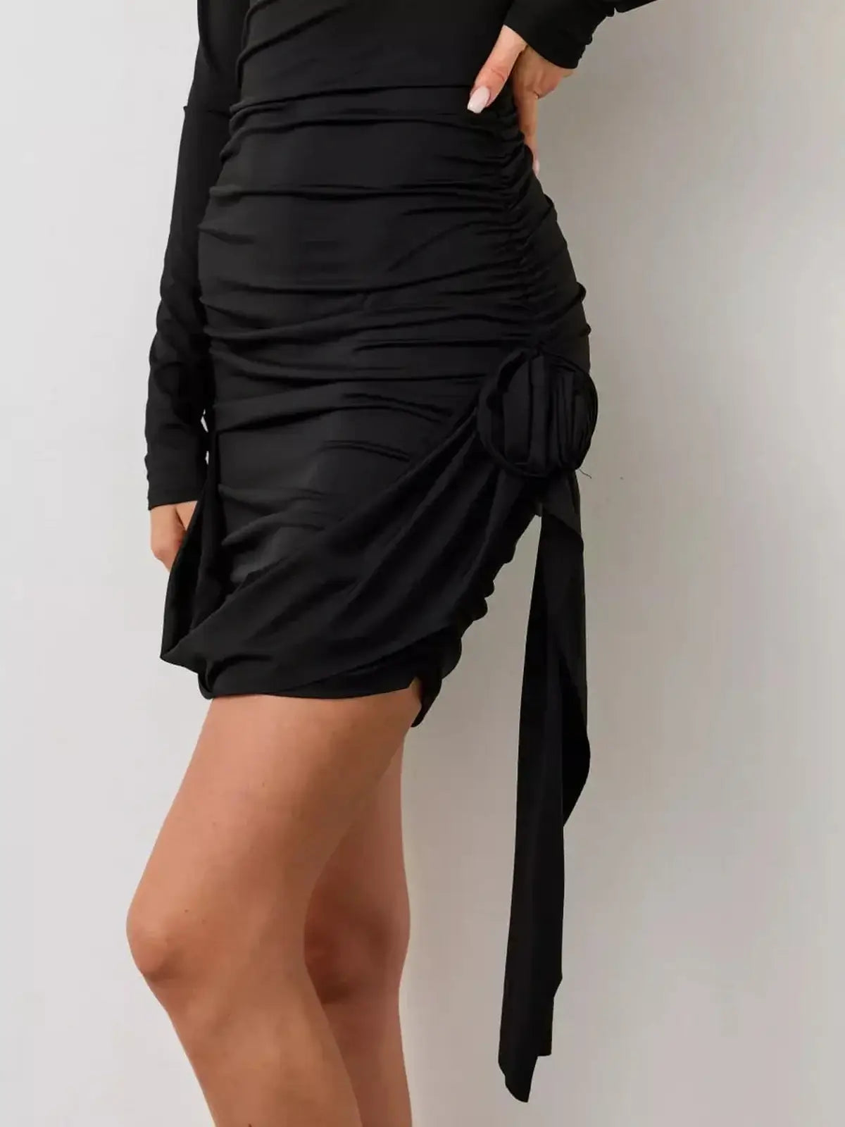 Elegant Rosette Noir black mini dress featuring ruched detailing and a stylish side rosette for a chic evening look.