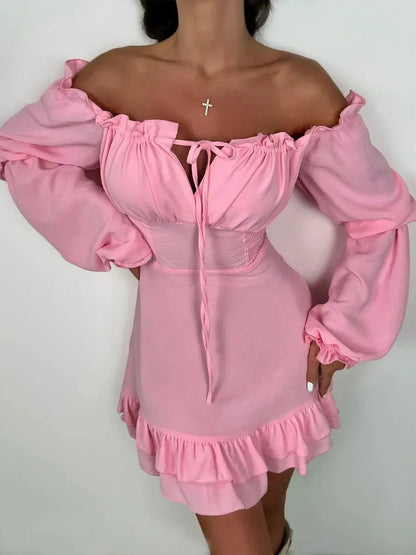 Off-shoulder pink mini dress with long sleeves and flouncy hem, perfect for summer and wedding guest attire.