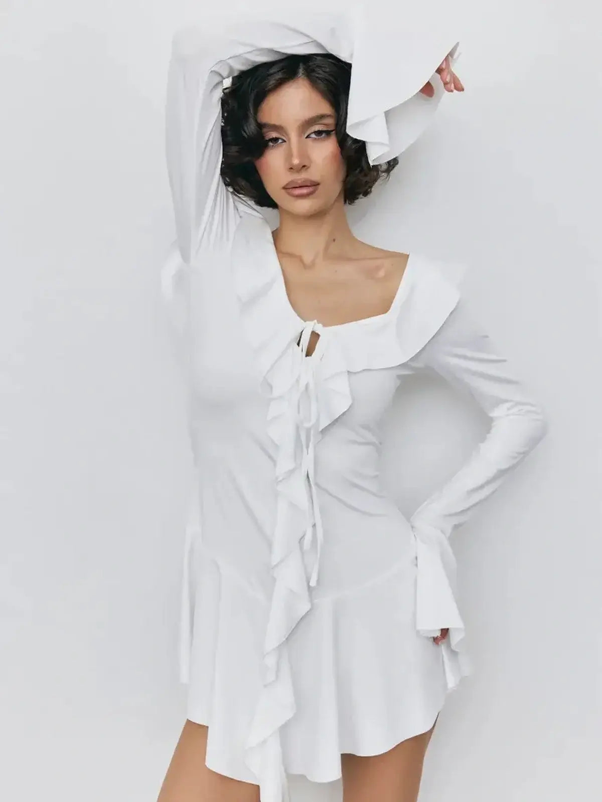 Model wearing a white mini dress with ruffles, perfect for summer, weddings, and parties.