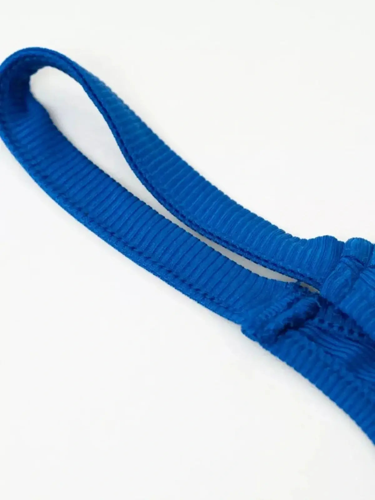 Close-up of the ribbed blue strap from the Sapphire Tide Mini Dress, showcasing its sporty design.