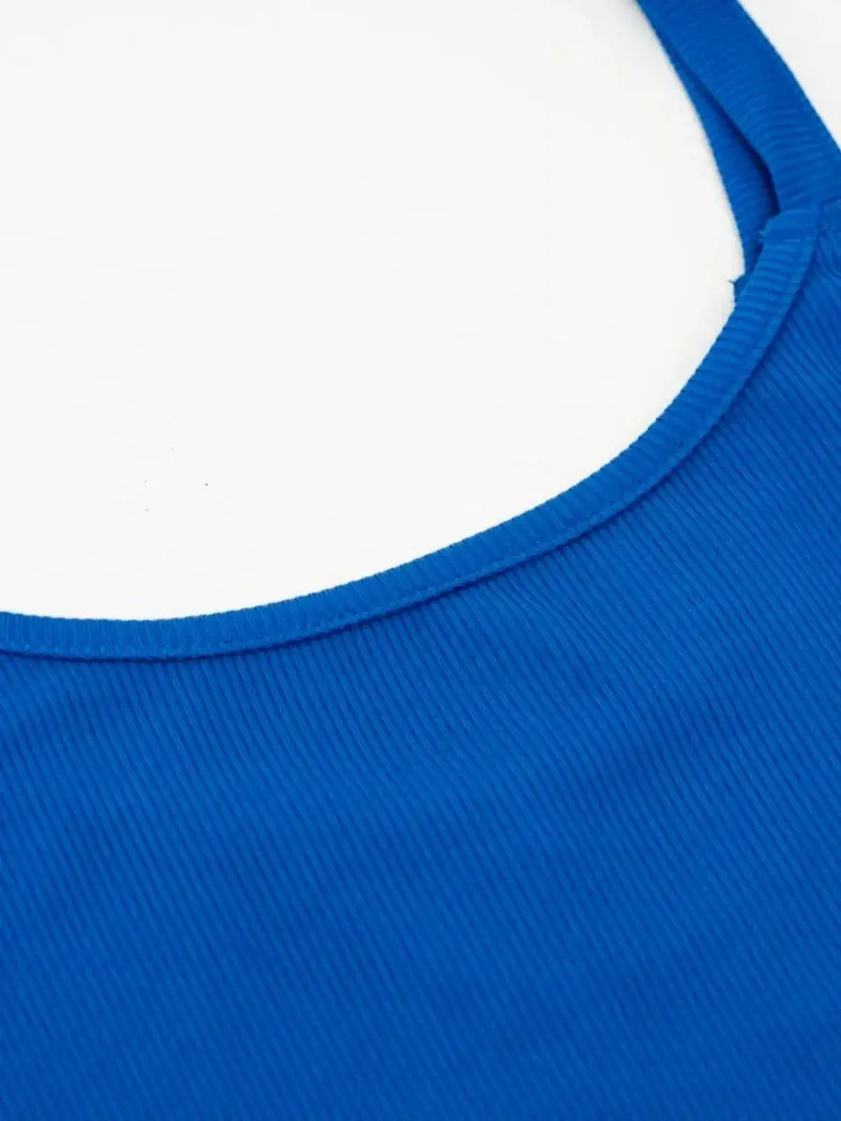 Close-up of the sapphire blue ribbed tank neckline of a mini dress, showcasing sporty summer style.