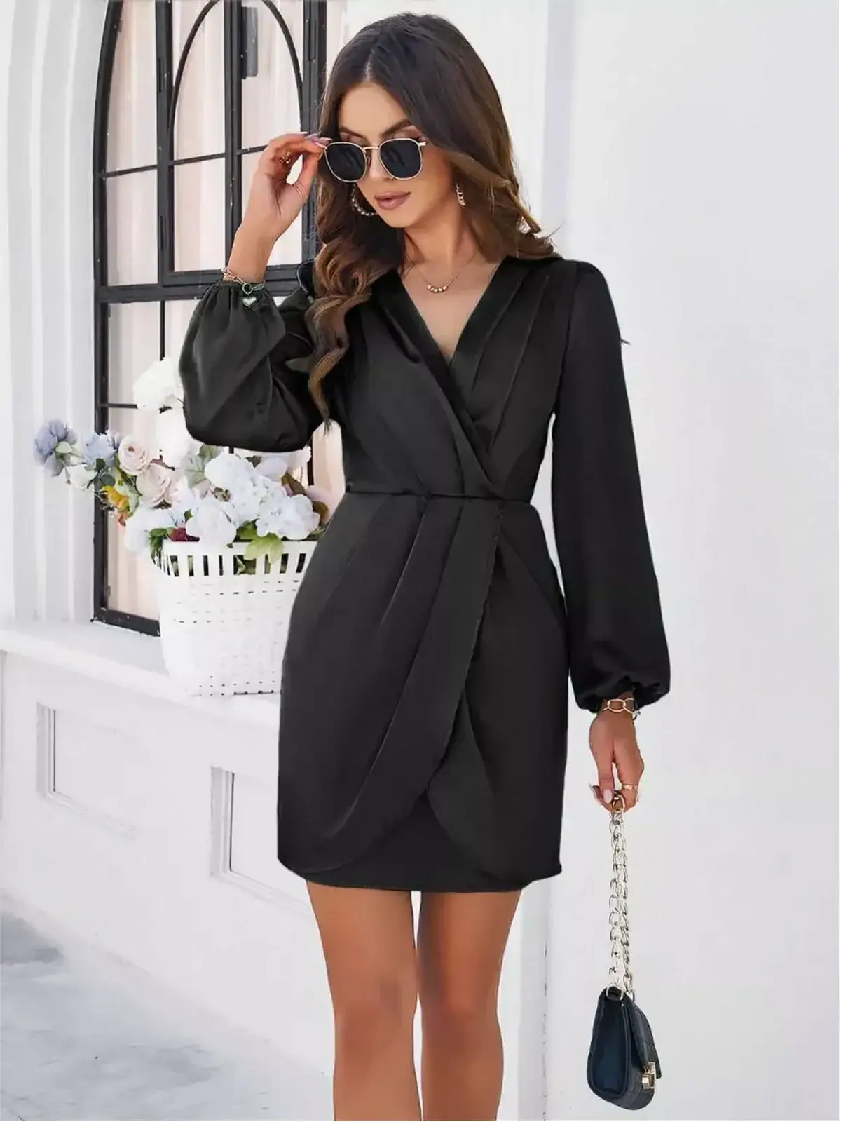 Elegant black satin drape mini dress with V-neckline and long sleeves, perfect for evening wear or wedding guest attire.
