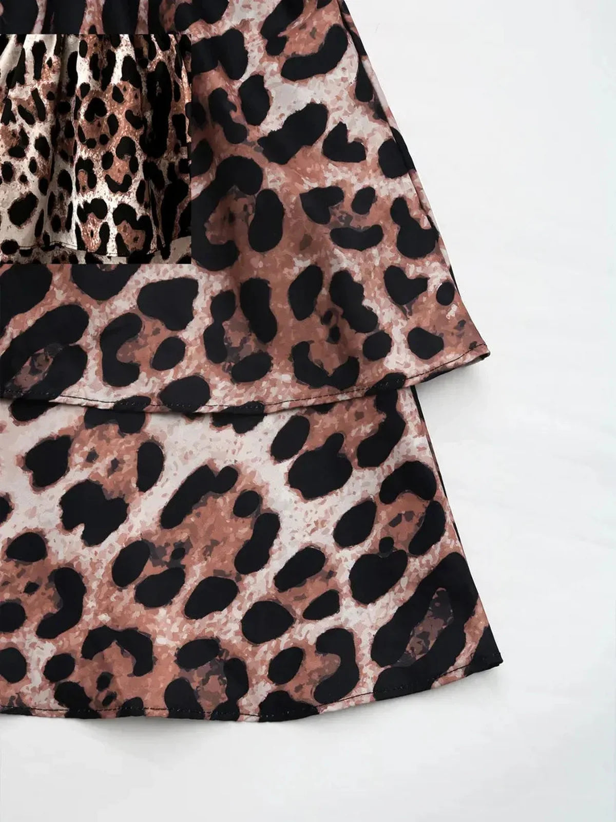 Savage Mood Mini Dress in bold leopard print, showcasing a layered ruffle skirt and smocked bodice.