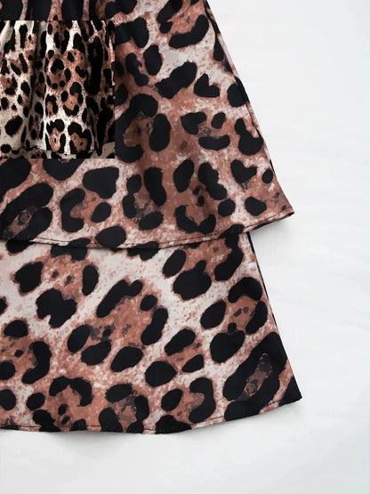 Savage Mood Mini Dress in bold leopard print, showcasing a layered ruffle skirt and smocked bodice.