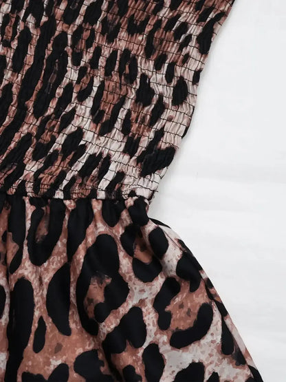 Close-up of the smocked bodice and ruffle skirt of a leopard print mini dress, showcasing playful summer fashion.
