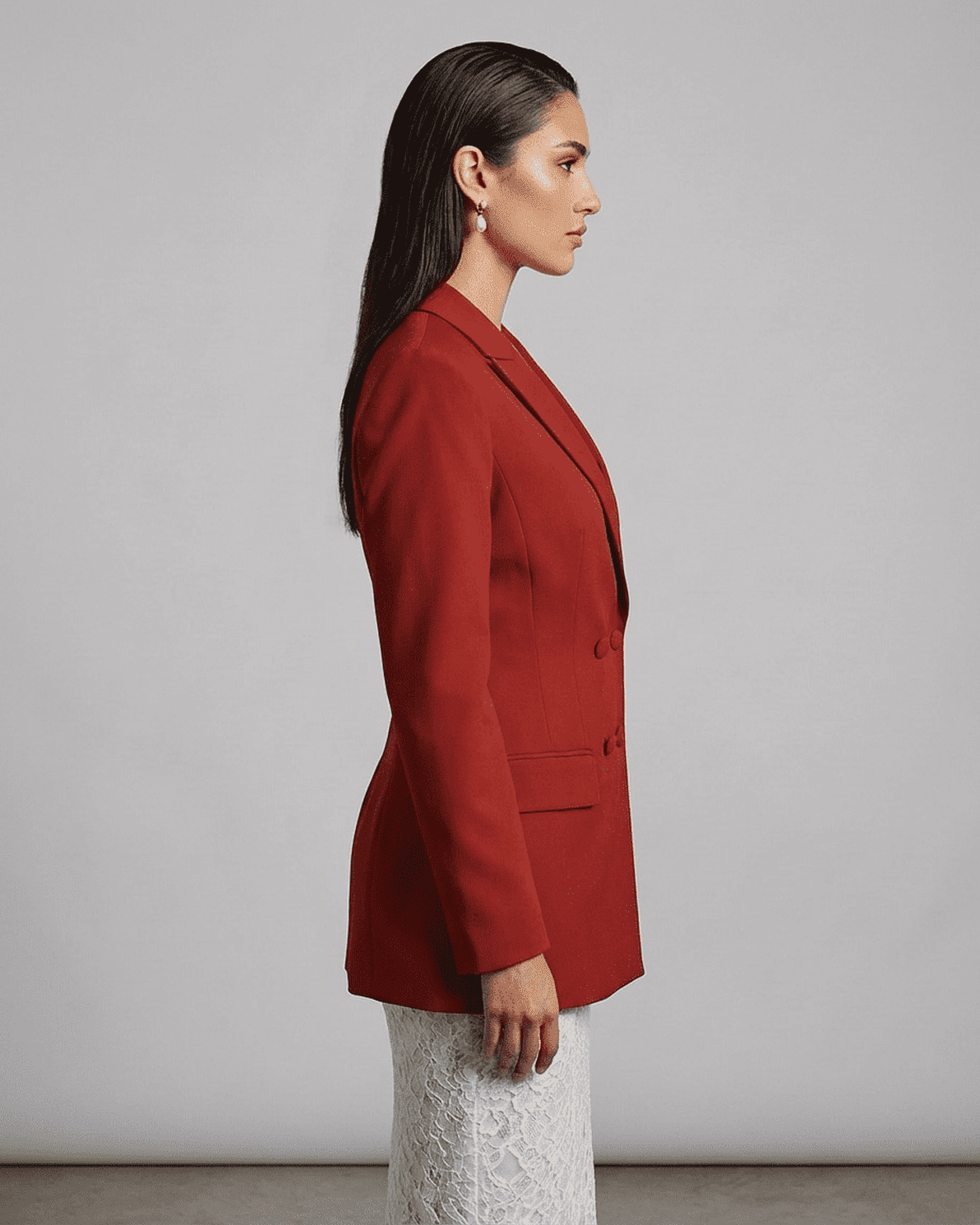 Profile view of a model wearing a Scarlet Blazer from Slimona, featuring sharp lapels and tailored silhouette.