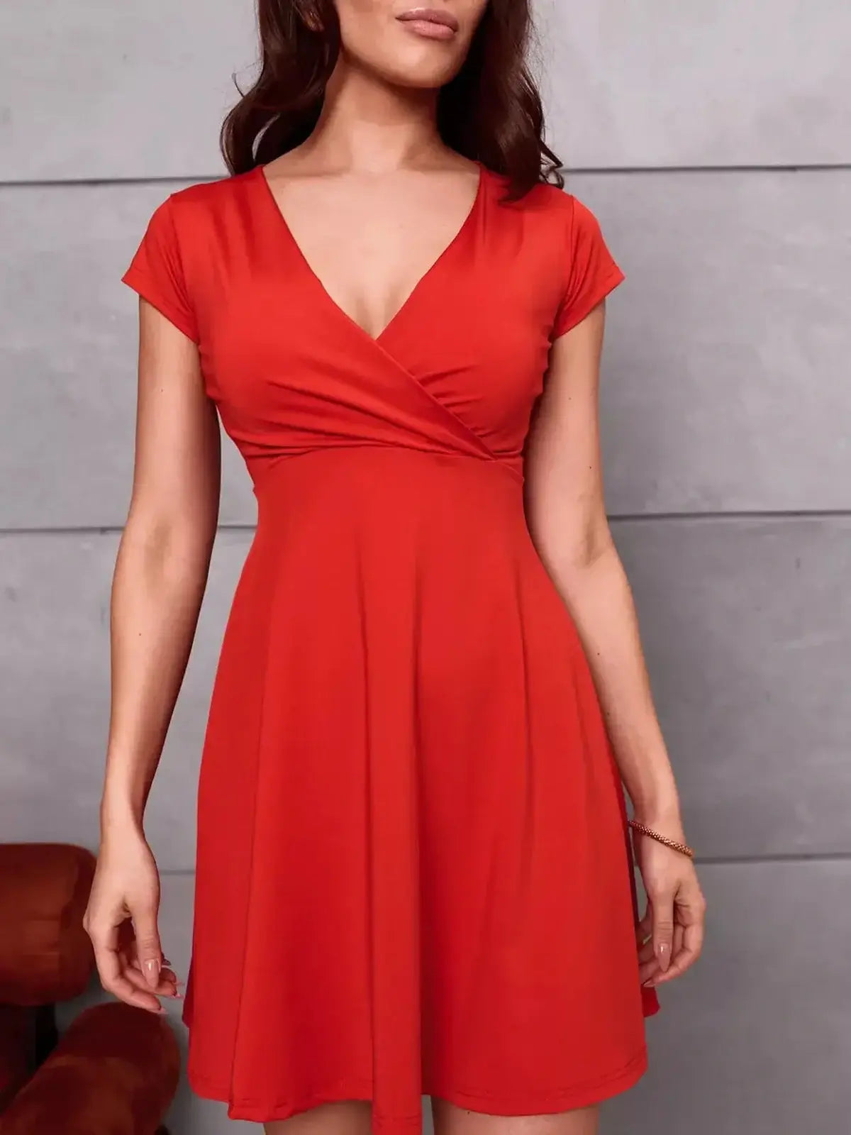 Flirty and elegant Scarlet Bloom Mini Dress in red, featuring a V-neckline and cap sleeves for a feminine silhouette.