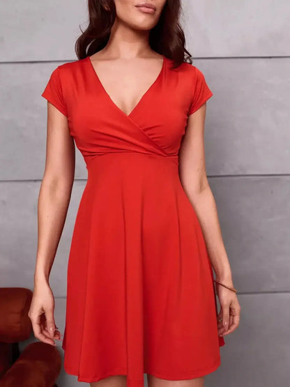 Flirty and elegant Scarlet Bloom Mini Dress in red, featuring a V-neckline and cap sleeves for a feminine silhouette.