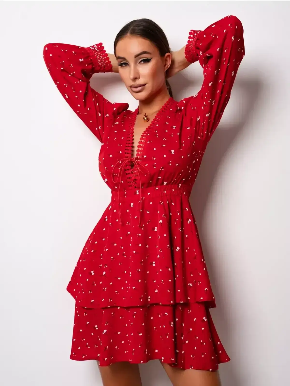 Model showcasing the bold red Scarlet Bloom mini dress with lace trim and puff sleeves, perfect for summer and party occasions.