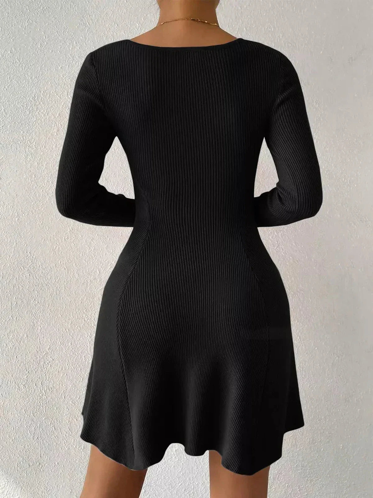Back view of a black Sculpt Knit Dress with long sleeves and a flared hem, flattering silhouette for women.
