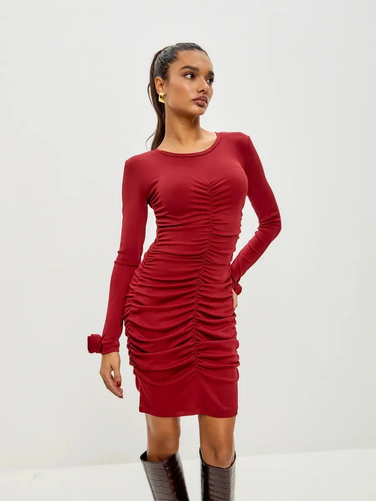 Elegant red bodycon dress with ruched details and long sleeves, perfect for party or formal occasions.