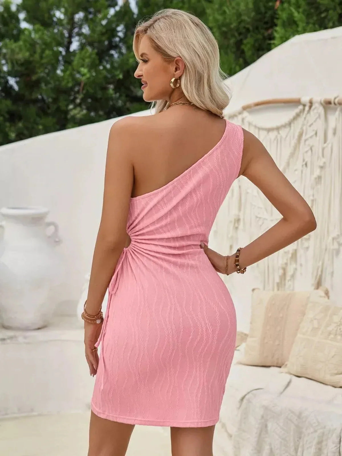 Sculpted One Mini Dress in pink, showcasing a sleek one-shoulder silhouette and gathered side detail, ideal for summer occasions.
